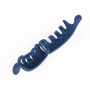 Close-up of blue plastic banana hair clip showing internal anti-slip teeth and metal hinge