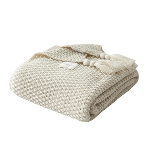 Nordic cream knitted throw blanket with fringe tassels and waffle texture