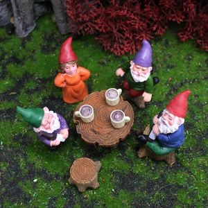 Miniature garden gnome set with resin figurines and a small table for outdoor decor
