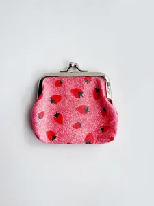 Detail of pink strawberry print coin purse with silver kiss-lock and glitter finish