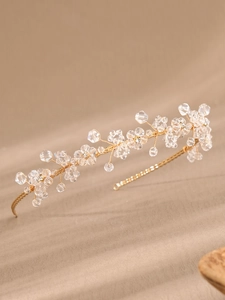 Detail of handcrafted gold wire headband with clear crystal beads and pearl flower motifs