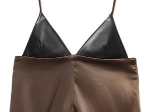 Detailed view of the black faux leather cup and brown satin patchwork camisole top