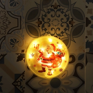 Detail of warm LED Christmas hanging light featuring Santa Claus on a geometric tile wall