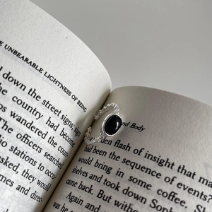 Vintage 925 silver open ring with black onyx stone placed in a book fold