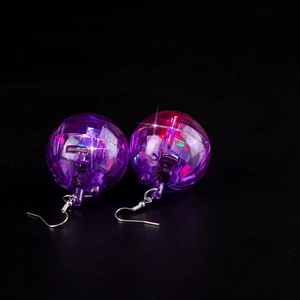 Macro view of purple disco ball earrings showing internal LED glowing effect and hooks