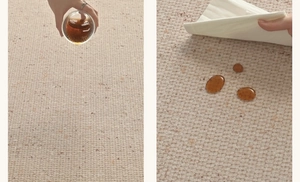 Waterproof testing on beige woven carpet showing liquid resistance and stain protection