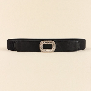 Close-up of a black elastic waist belt featuring a sparkling rhinestone rectangular buckle