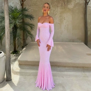 Detailed view of pink off-shoulder lace mermaid evening dress with long sleeves in sunlight
