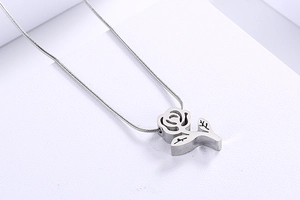 Detailed view of a silver rose flower pendant featuring a sleek snake chain design