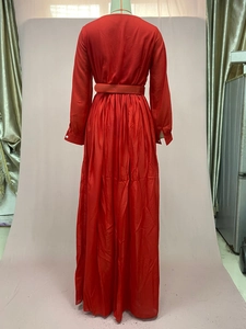 Rear view of a bright red maxi dress featuring a high-waist design and long sleeves