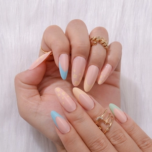 Close-up of long almond fake nails with pastel French tips and small floral patterns