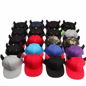 Detail view of colorful hip hop caps with devil horn design and various camo patterns
