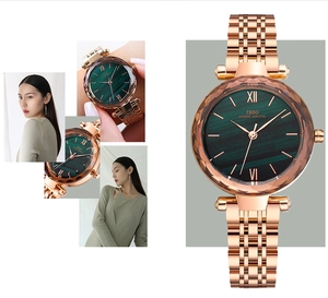 Detail of rose gold watch with faceted glass and green malachite pattern dial