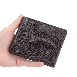 Brown faux crocodile leather wallet for men with textured pattern held in hand