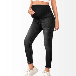 Detail of high-waist support band on skinny maternity jeans in washed charcoal grey denim