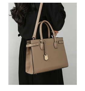 Taupe tote bag with lychee texture stitching and detachable strap shown on a model