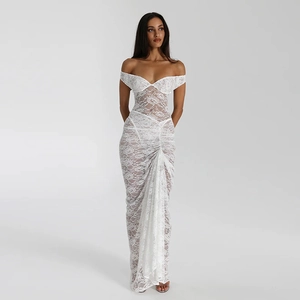 Close-up of white lace tube top dress with elegant ruched long skirt and sheer details