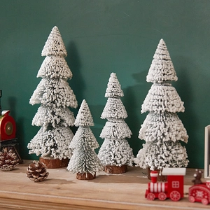 Miniature snow-flocked Christmas tree set with wooden bases for festive tabletop decor