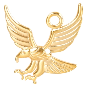 Macro shot of a golden eagle pendant with detailed wings for DIY jewelry crafting