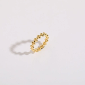 Detail of 14K gold plated beaded ring showing polished metallic spheres on white background