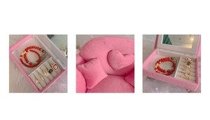 Pink plush sofa jewelry box with heart pillow showing ring slots and bracelet storage