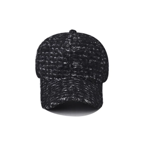 Detail of black and white tweed texture on a six-panel winter baseball cap with curved brim