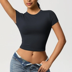 Close-up of slim fit black sports crop top with round neck and high-elastic knit fabric