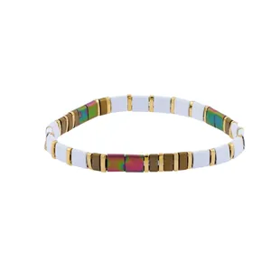 Close-up of colorful square elastic beads with iridescent and golden metallic finish