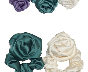 Detail of five silk satin oversized rose hair scrunchies in purple green and beige