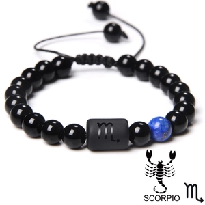Detailed view of Scorpio adjustable black beaded bracelet with engraved zodiac charm