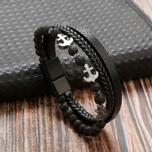 Detail of multilayer men's leather bracelet with volcanic stone beads and silver anchors