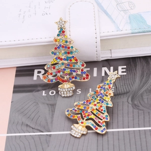 Close-up of sparkling colorful rhinestones on a gold hollow Christmas tree earring