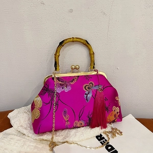 Silk embroidered handbag with magenta butterfly pattern, bamboo handle, and gold chain strap
