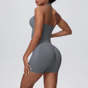 Detail view of high-waist yoga shorts with V-seam and halter neck sports bra in charcoal grey