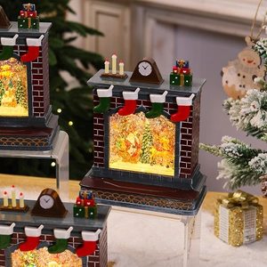 Close-up of lighted fireplace Christmas music box with Santa and reindeer scenery
