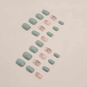Short square press-on nails with pale green gradient and delicate leaf hand-painted designs