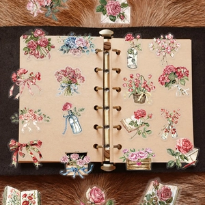 Vintage floral stickers and letter motifs on a ring binder with roses and hydrangea