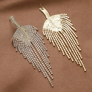 Detailed front and back views of gold leaf tassel earrings with sparkling rhinestones