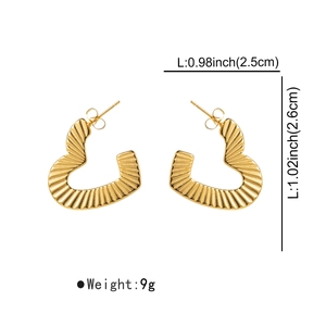 Detail view of heart-shaped gold earrings with textured radial pleats and size measurements