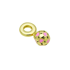 Close-up of golden spherical charm with pink enamel heart patterns on white background