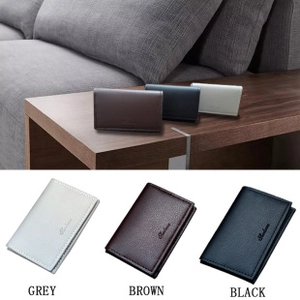 Three men's leather wallets in grey, brown, and black colors on a wooden surface