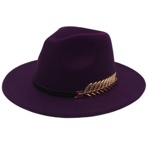Detail of dark purple wool fedora with black leather band and gold feather metal accent