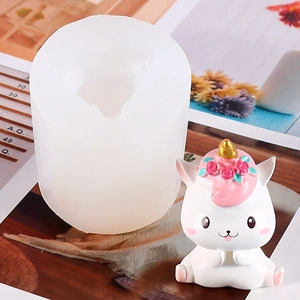 Detail of translucent silicone unicorn mold alongside a hand-painted finished resin craft