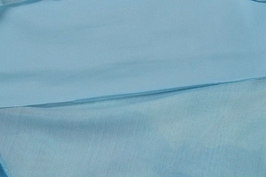 Vue macro détaillée du mesh bleu clair et de la texture du tissu en maille de la robe