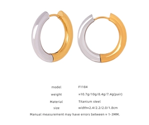 Detailed view of two-tone gold and silver titanium steel hoop earrings in various sizes