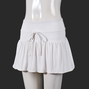 Detail view of white mini skirt showing the drawstring waistband and pleated texture