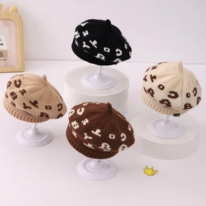 Collection of autumn knitted berets for kids in beige, khaki, brown, and black colors