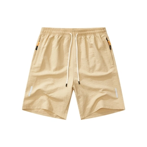 Men's khaki quick-dry athletic shorts with drawstring waist and orange zipper pockets