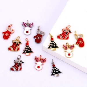 Macro view of Christmas charms like reindeer and trees with gold plating and enamel inlay