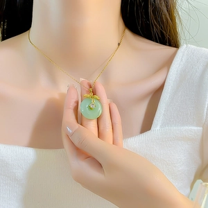 Elegant green jadeite pendant necklace with gold metal leaf and diamond accent for women